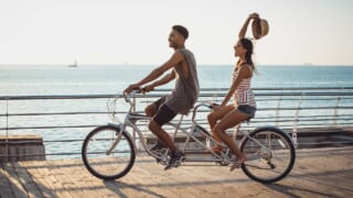 タンデム自転車に乗るカップルのイメージ