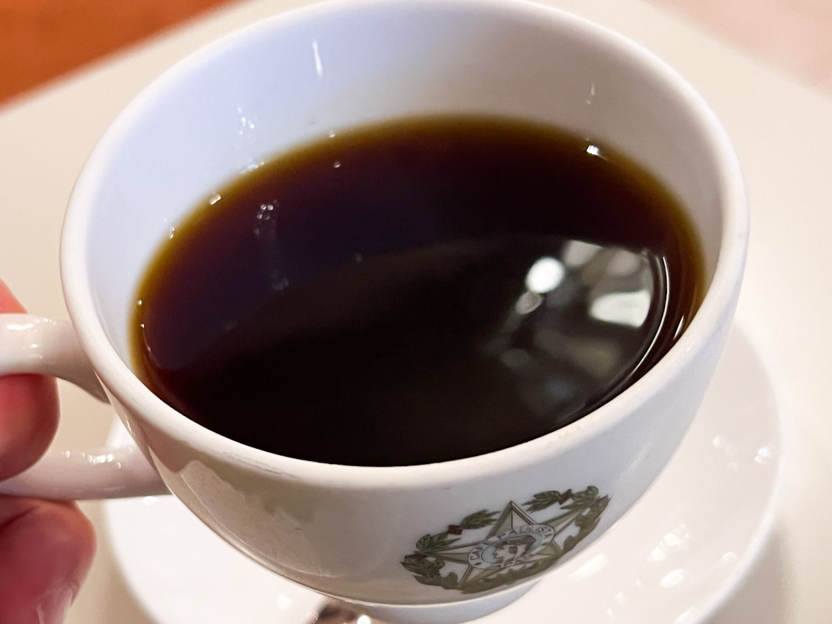 手に持った「カフェーパウリスタ銀座本店」の「森のコーヒー」