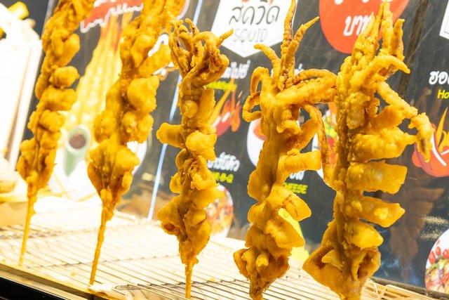タラートロットファイラチャダー（ラチャダー鉄道市場）の屋台で売られているイカ焼き